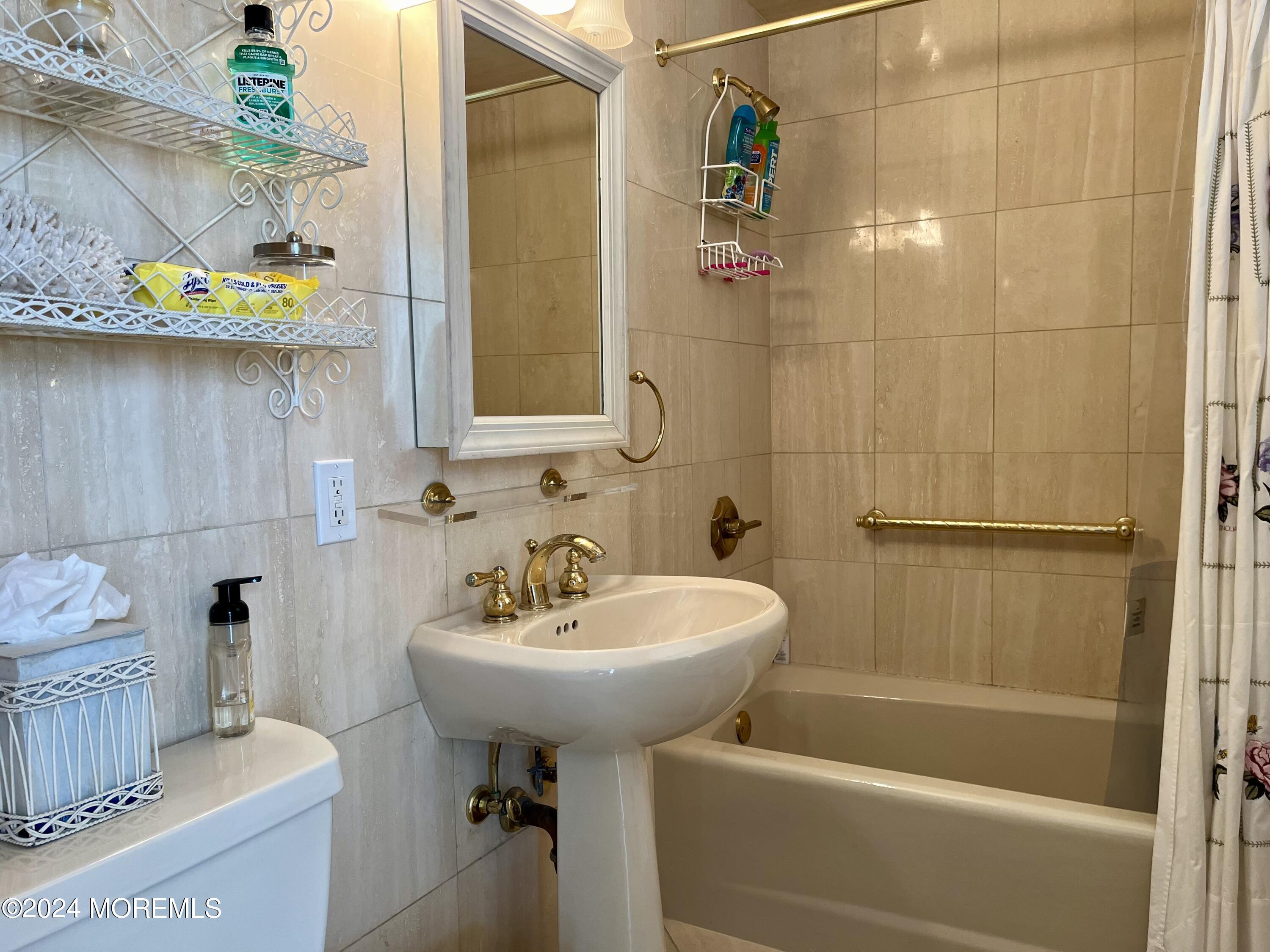 700 Ocean Avenue, Unit G38 Spring Lake, NJ 07762 - Photo 7 of 37 a bathroom with a sink a toilet and shower