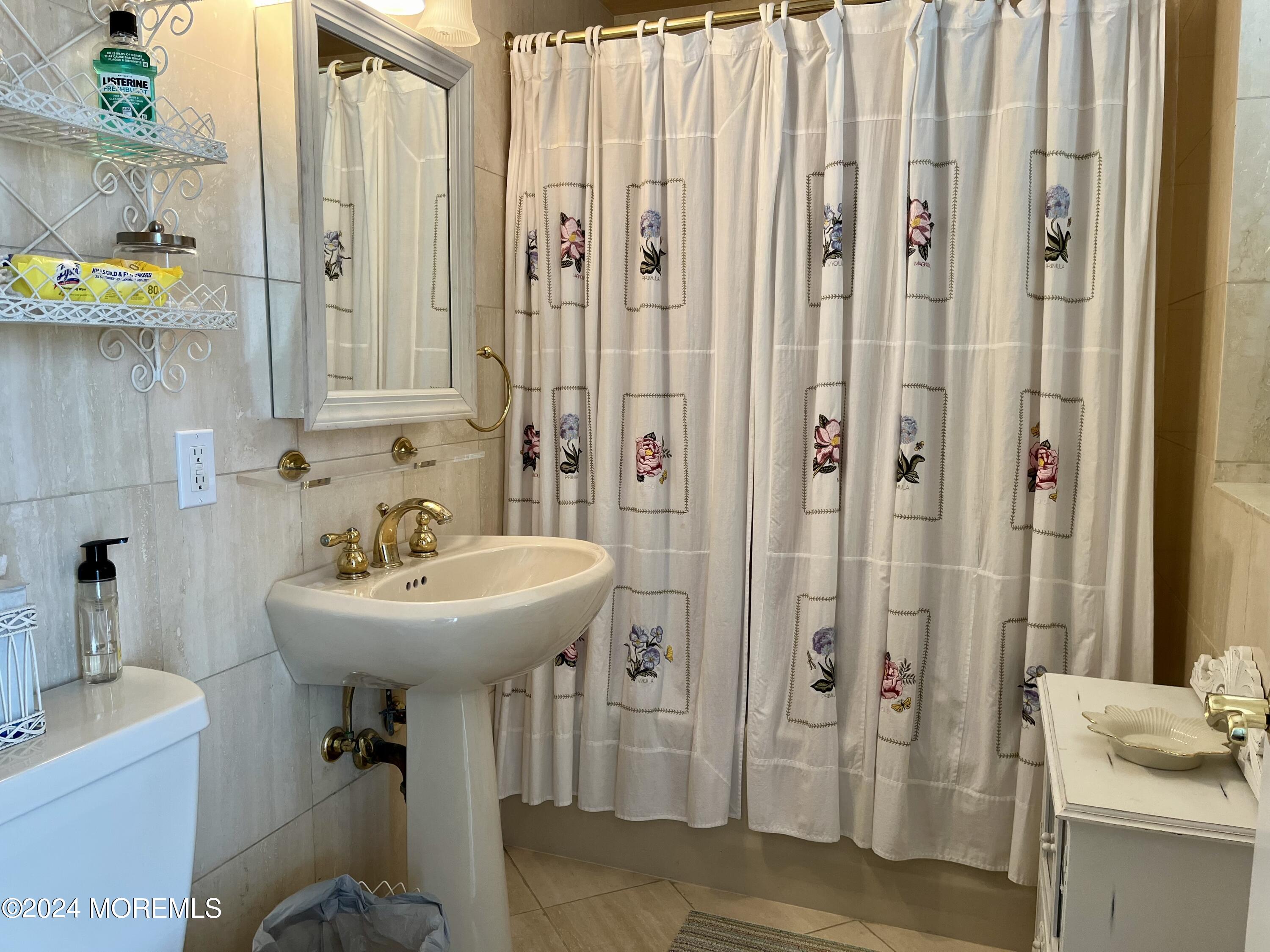 700 Ocean Avenue, Unit G38 Spring Lake, NJ 07762 - Photo 8 of 37 a bathroom with a sink a mirror and shower