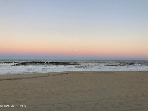 a view of an ocean beach and mountain