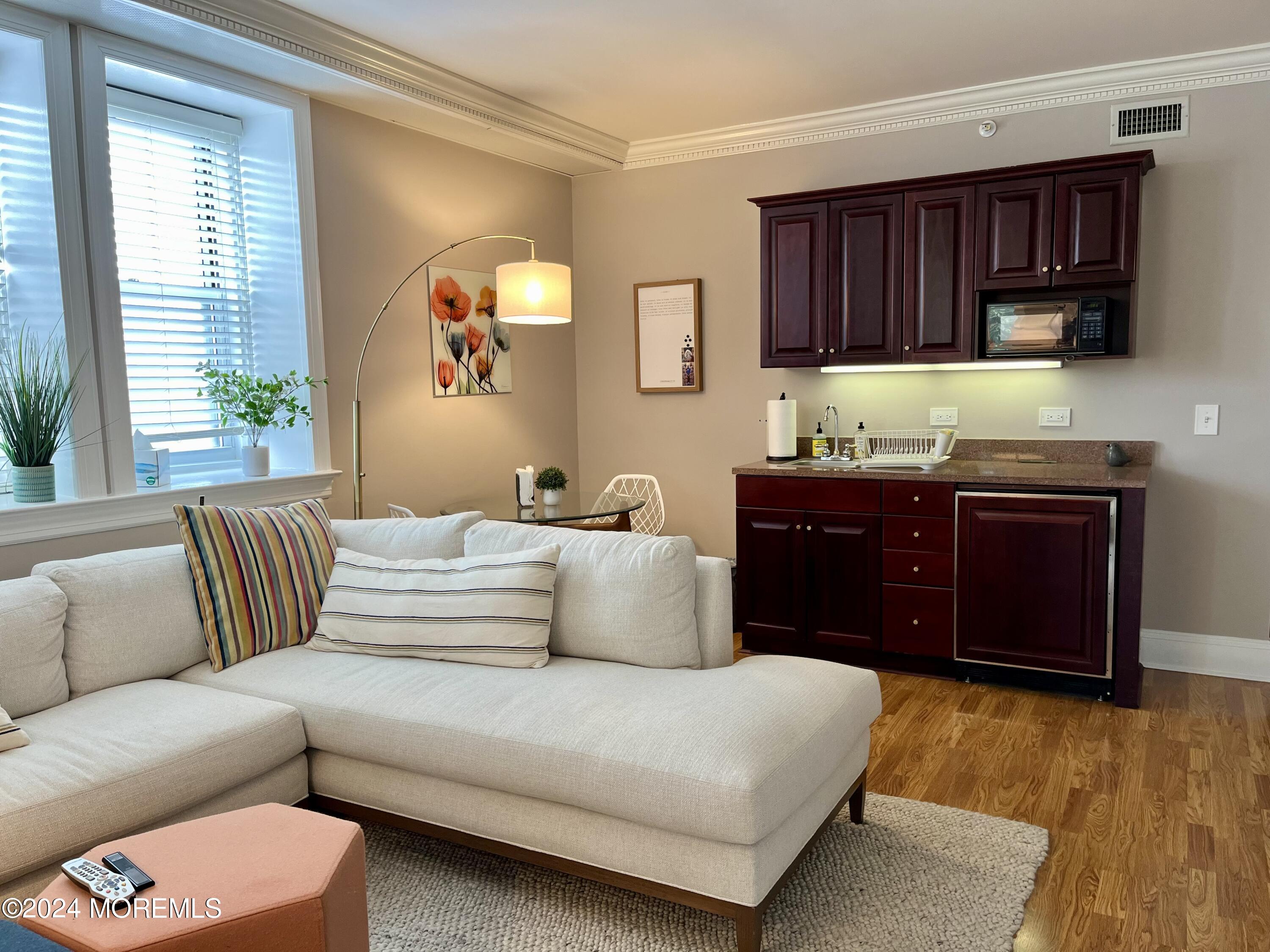 700 Ocean Avenue, Unit G38 Spring Lake, NJ 07762 - Photo 10 of 37 a living room with a couch and a dresser