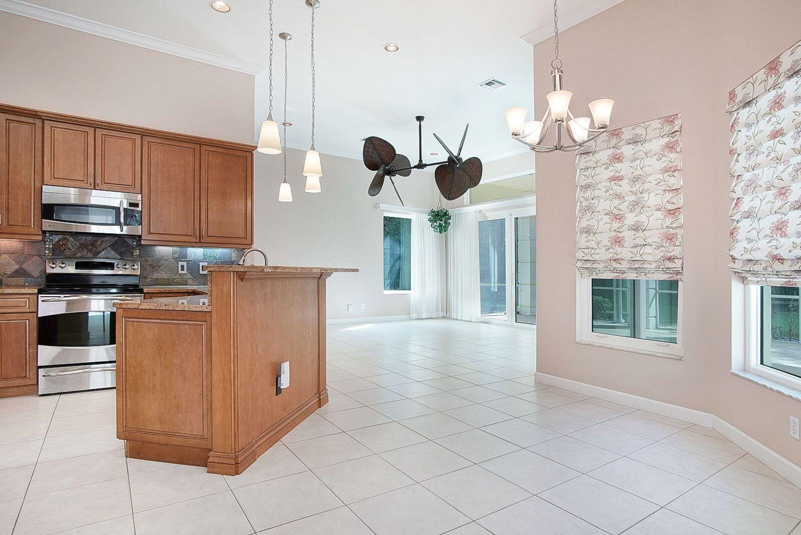 5496 Southeast Reef Way Stuart, FL 34997 - Photo 16 of 35 a kitchen with cabinets and window