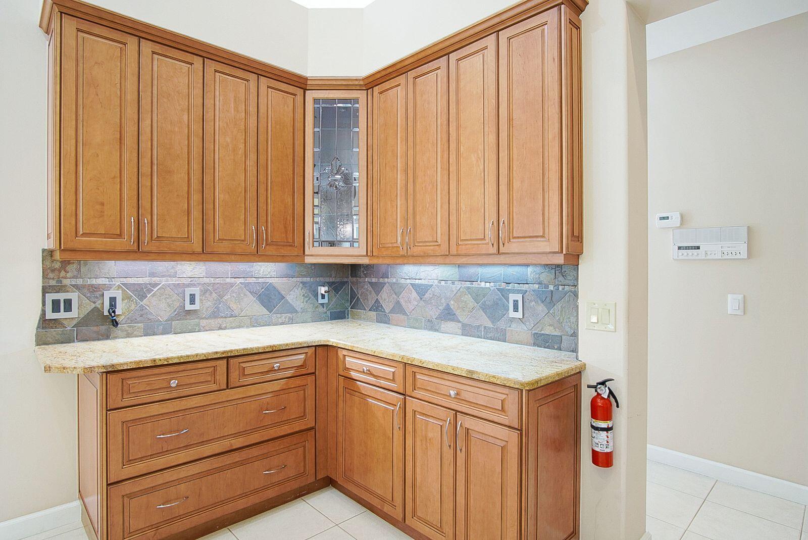 5496 Southeast Reef Way Stuart, FL 34997 - Photo 17 of 35 a utility room with granite countertop cabinets and washer