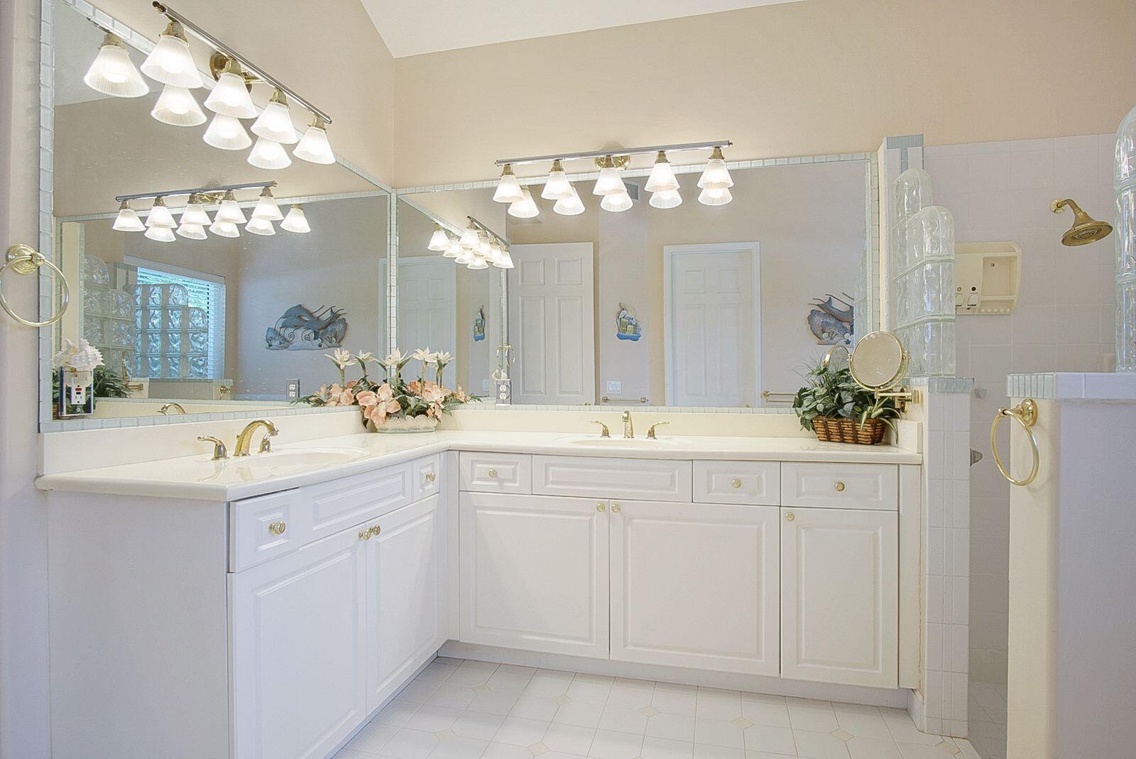 5496 Southeast Reef Way Stuart, FL 34997 - Photo 19 of 35 a bathroom with a sink vanity and a mirror