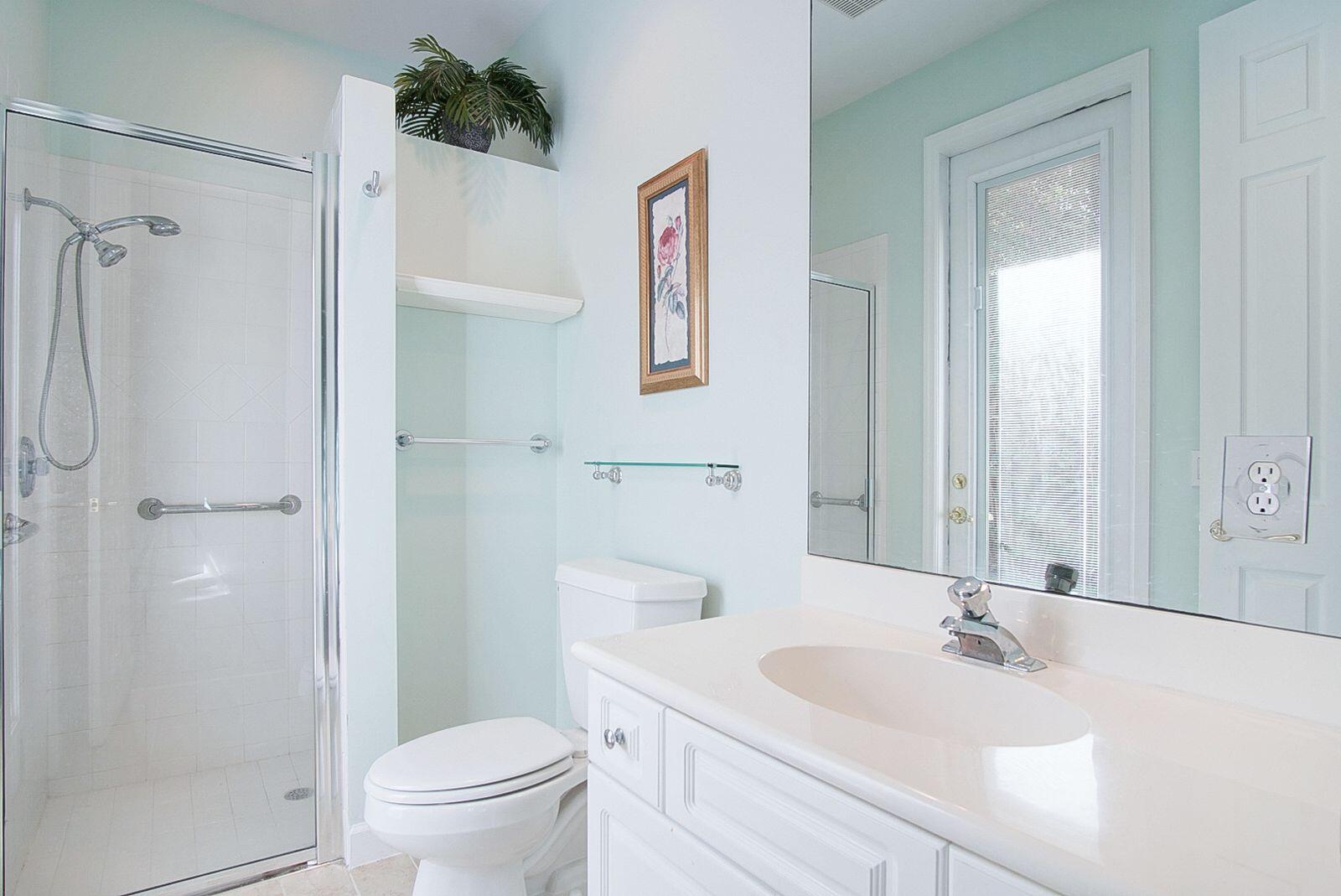 5496 Southeast Reef Way Stuart, FL 34997 - Photo 20 of 35 a bathroom with a sink a toilet and shower