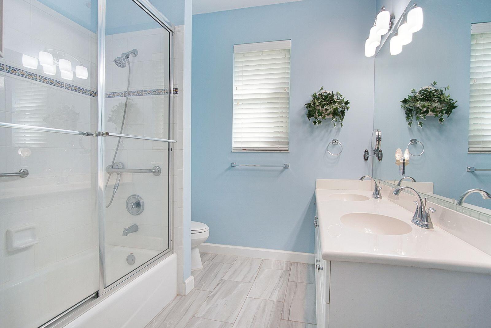 5496 Southeast Reef Way Stuart, FL 34997 - Photo 22 of 35 a bathroom with a bathtub sink and shower