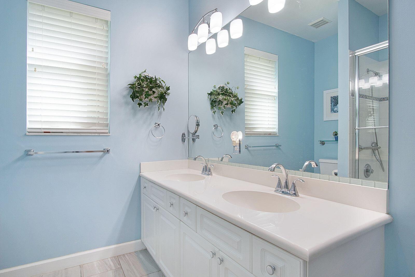 5496 Southeast Reef Way Stuart, FL 34997 - Photo 23 of 35 a bathroom with a sink a vanity and a mirror