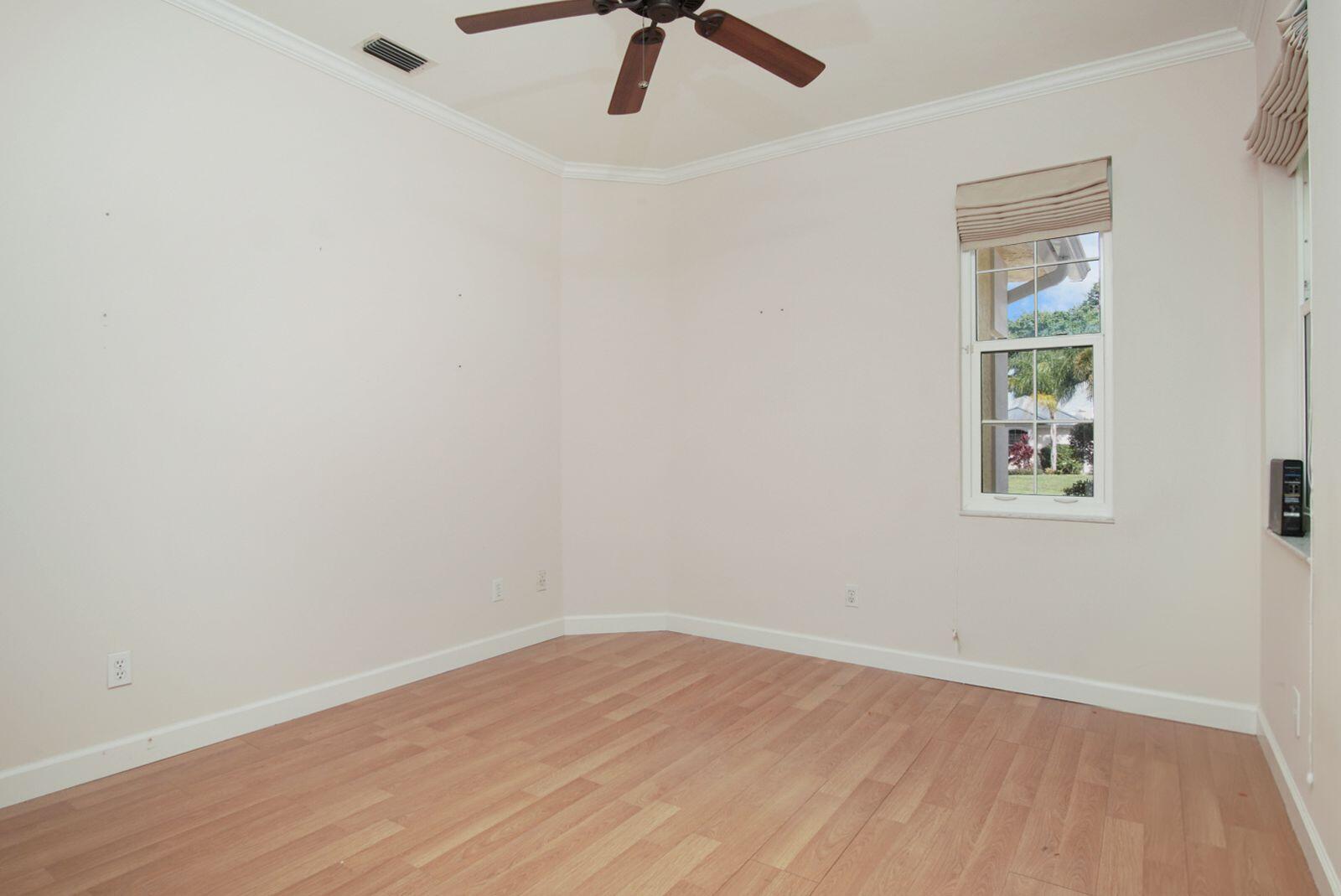 5496 Southeast Reef Way Stuart, FL 34997 - Photo 27 of 35 an empty room with a window and ceiling fan