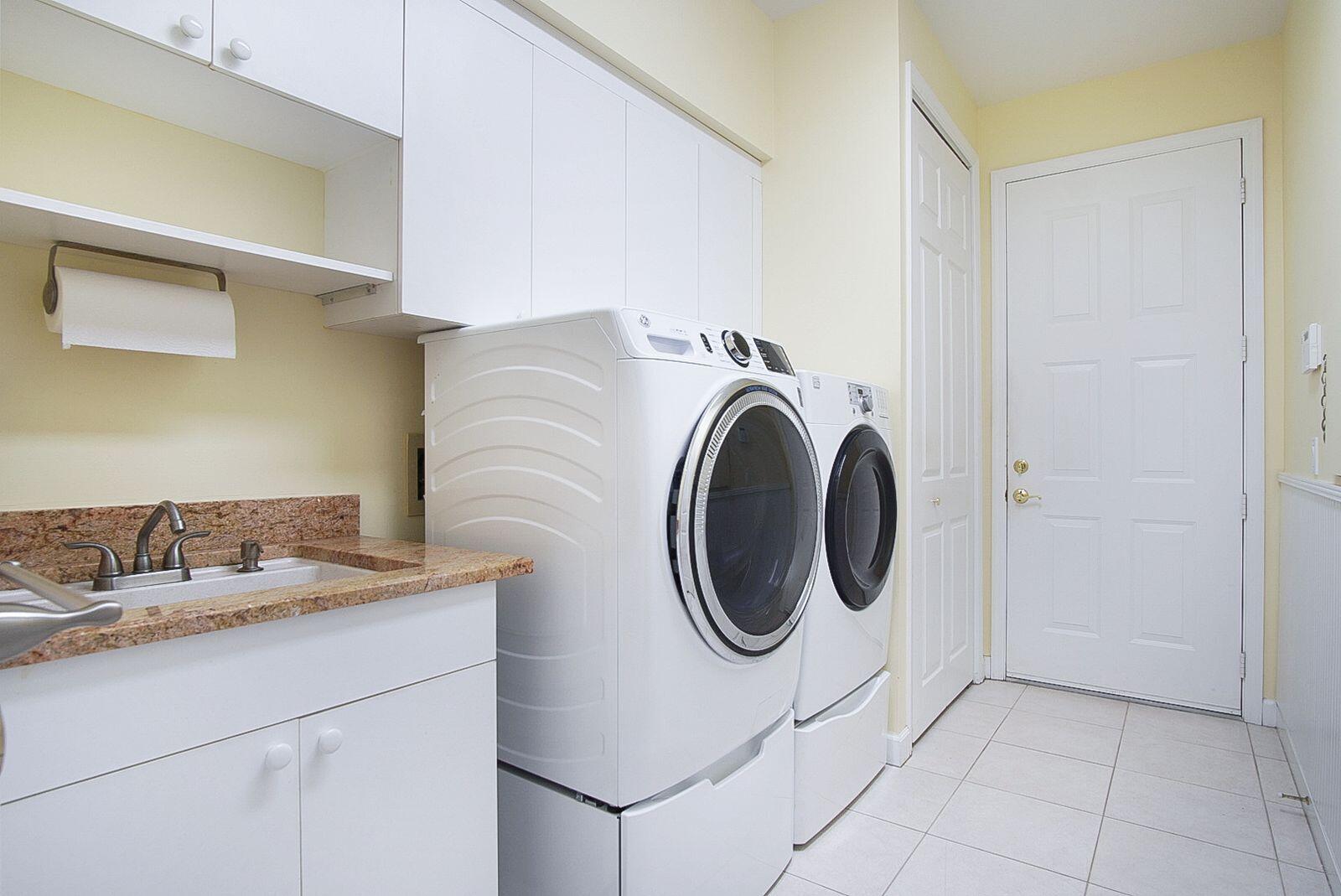 5496 Southeast Reef Way Stuart, FL 34997 - Photo 29 of 35 a utility room with sink dryer and washer