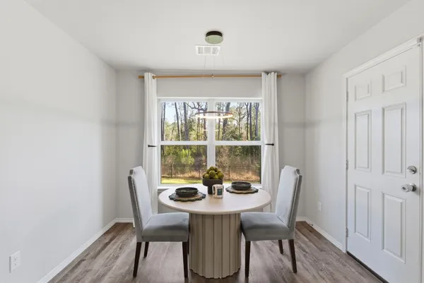 a view of a dining room with furniture window and wooden floor