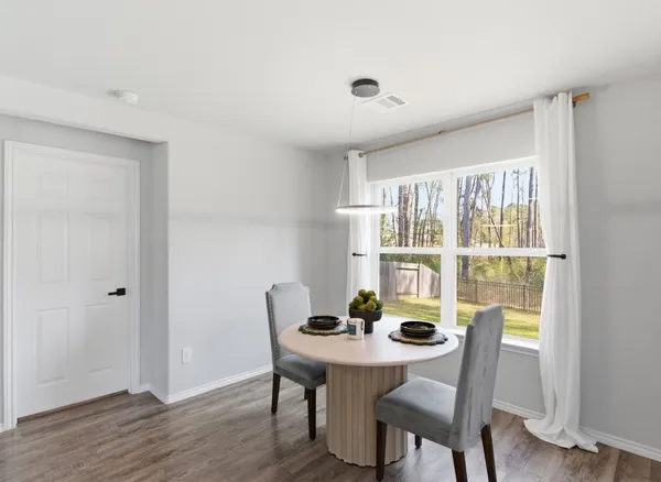 a view of a dining room with furniture window and wooden floor