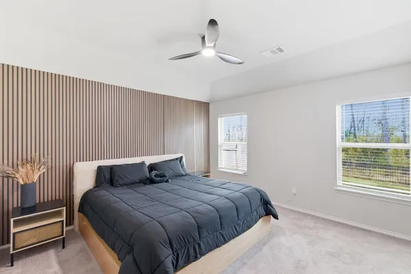 a bedroom with a large bed and a window