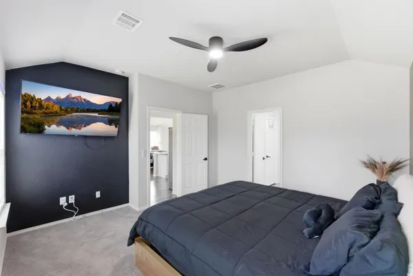 a bedroom with a bed and a painting on the wall