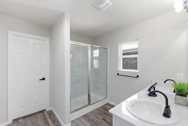 a bathroom with a sink and shower