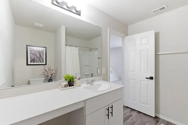 a bathroom with a double vanity sink and a mirror