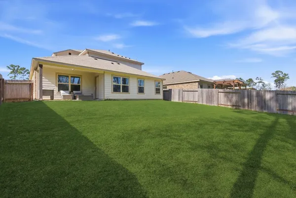 a front view of a house with a garden and yard