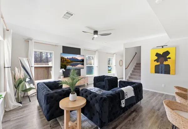 a living room with fireplace furniture and a wooden floor