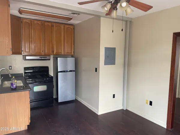 a kitchen with a refrigerator and a stove top oven