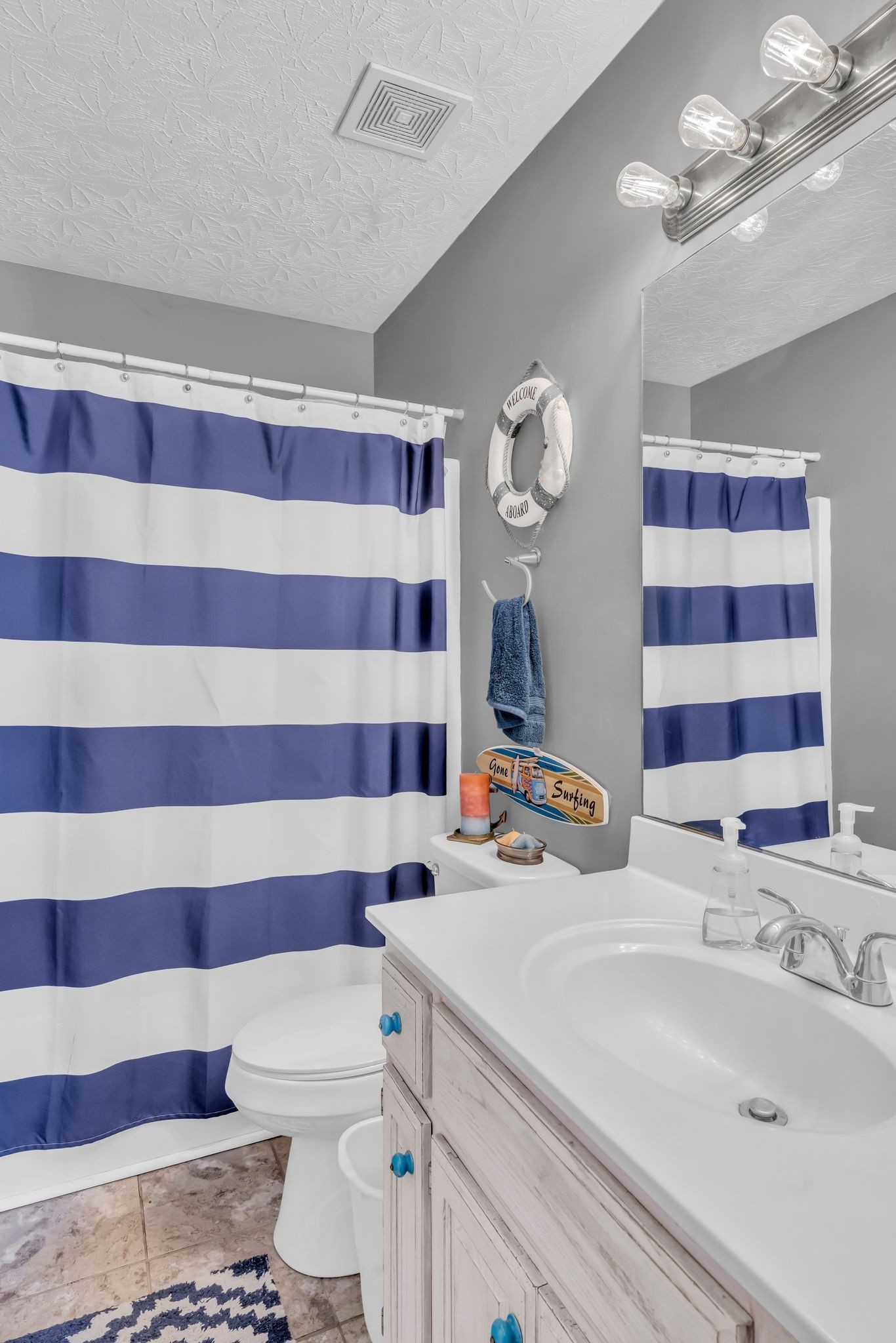 2450 Scotty Parker Road Portland, TN 37148 - Photo 18 of 37 a bathroom with a sink a toilet a large mirror and shower curtain
