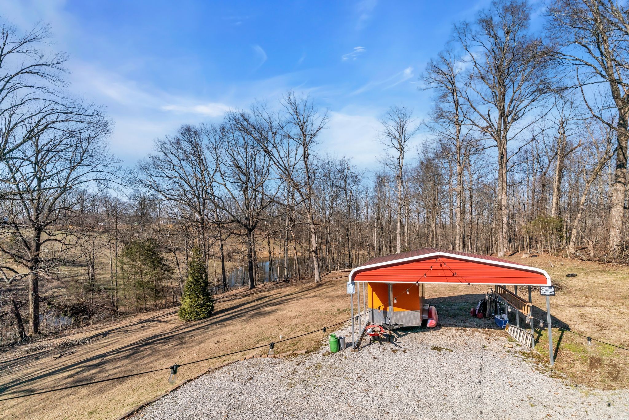 2450 Scotty Parker Road Portland, TN 37148 - Photo 29 of 37 a view of a yard with a table and chairs under an umbrella