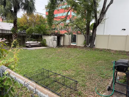 a white house that has a tree in front of it
