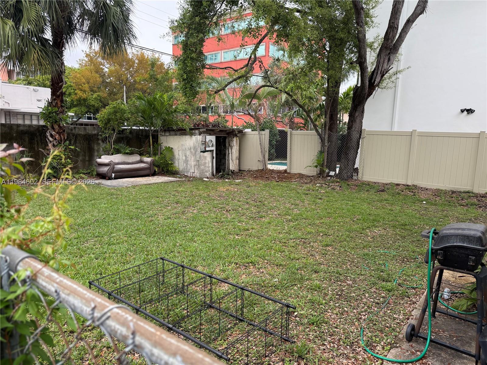 1395 Southwest 22nd Terrace Miami, FL 33145 - Photo 4 of 7 a white house that has a tree in front of it