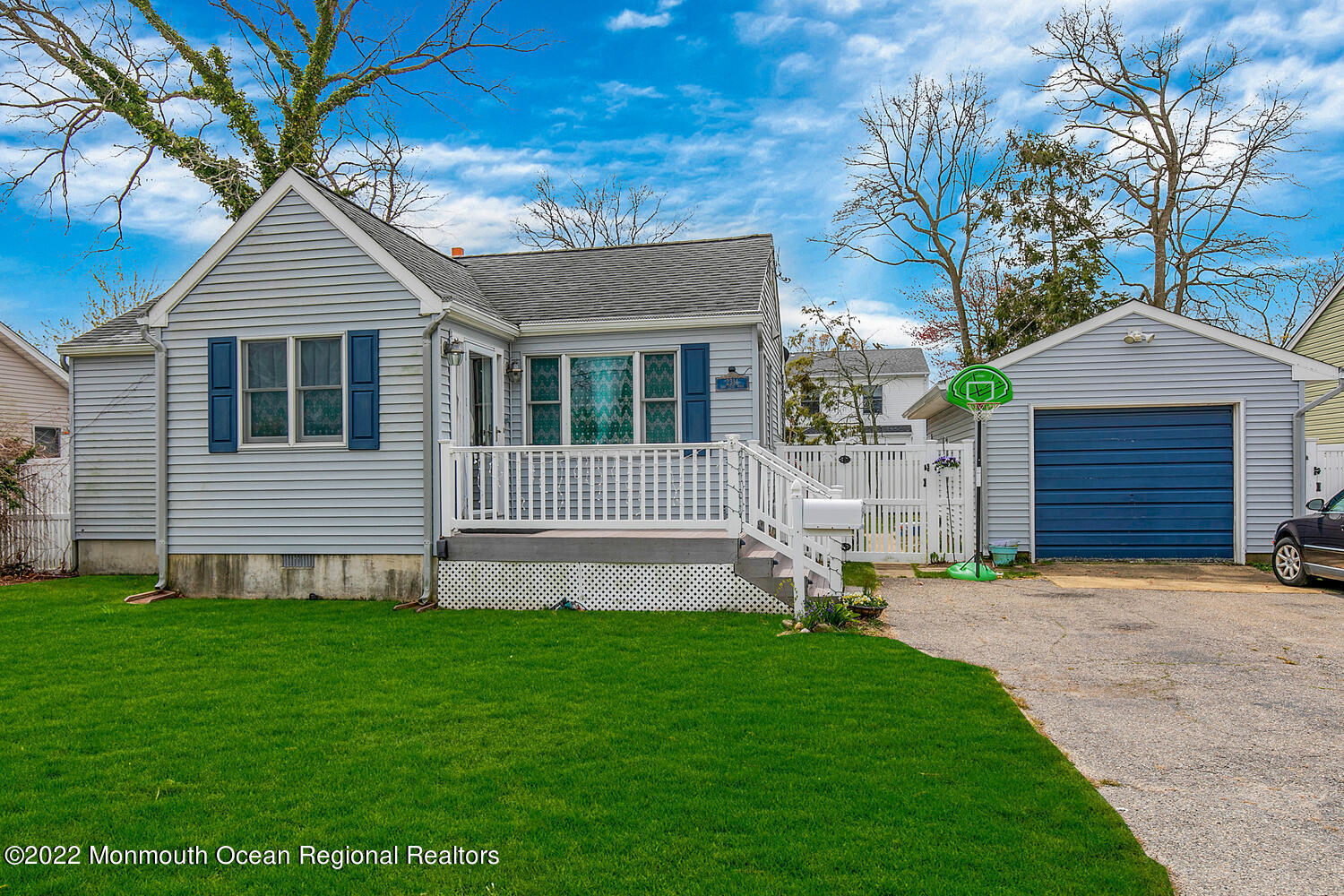 2314 Oak Tree Road Point Pleasant, NJ 08742 - Photo 1 of 17 a white house with a small yard and large trees