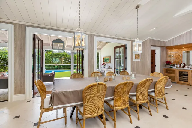 a dining room with furniture a chandelier and wooden floor