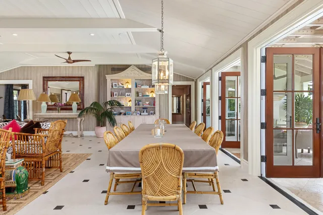 a view of a dining room with furniture large windows and wooden floor