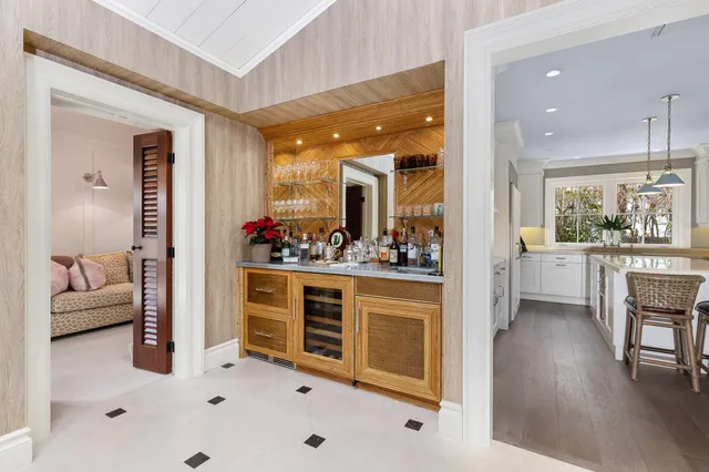 a kitchen with a stove a sink a dining table and chairs