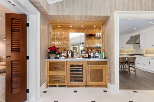 a kitchen that has a lot of white cabinets and stainless steel appliances