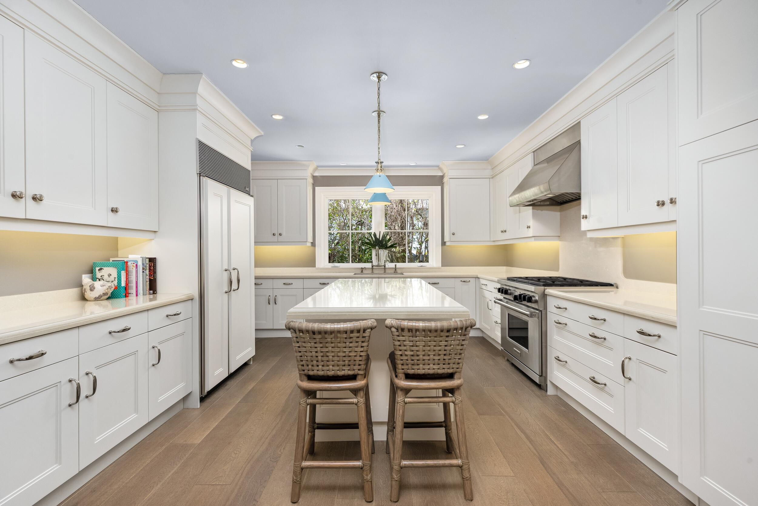258 List Road Palm Beach, FL 33480 - Photo 18 of 49 a kitchen with stainless steel appliances kitchen island granite countertop a table chairs and a sink