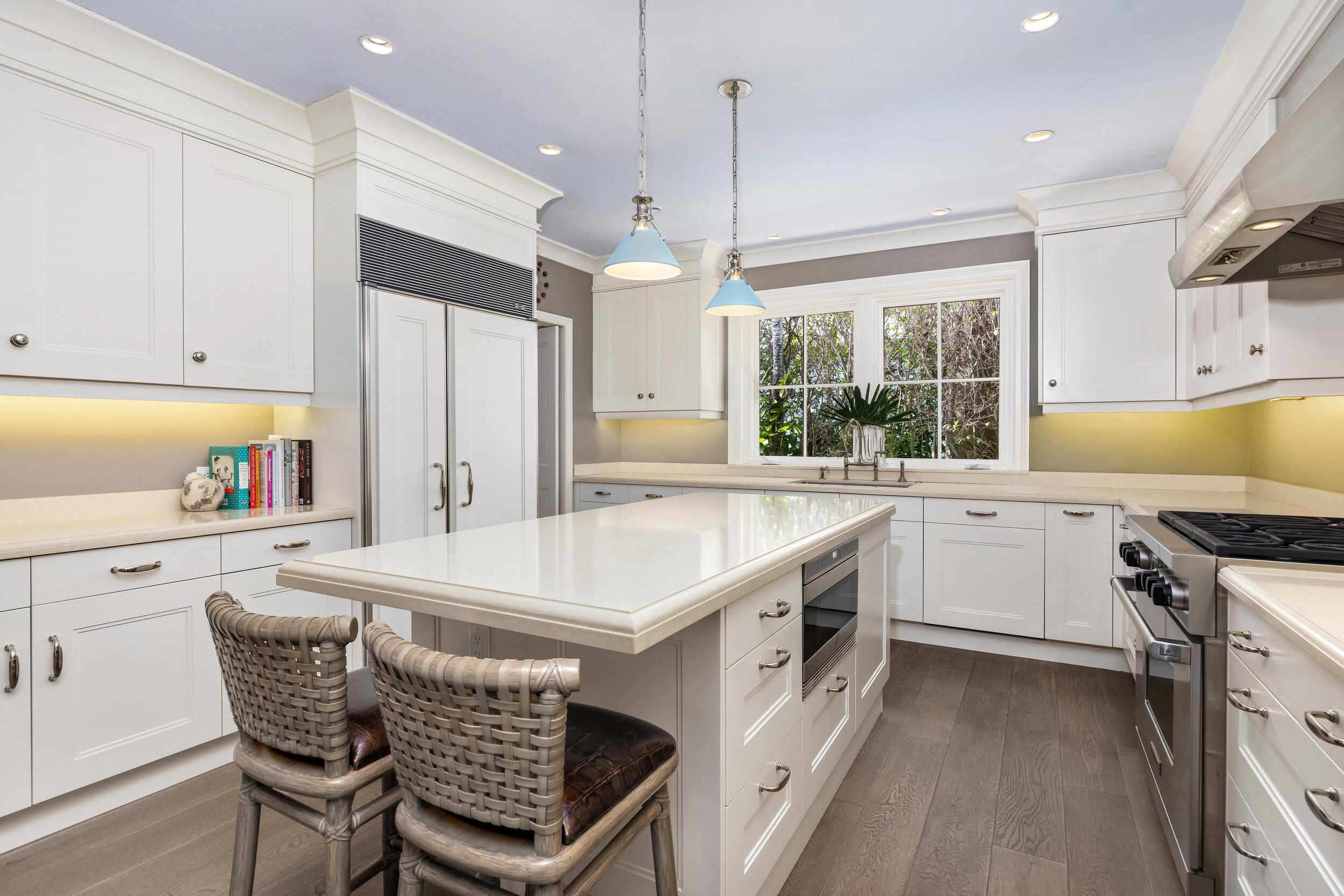 258 List Road Palm Beach, FL 33480 - Photo 19 of 49 a kitchen with stainless steel appliances granite countertop a stove a sink a kitchen island with a dining table and chairs