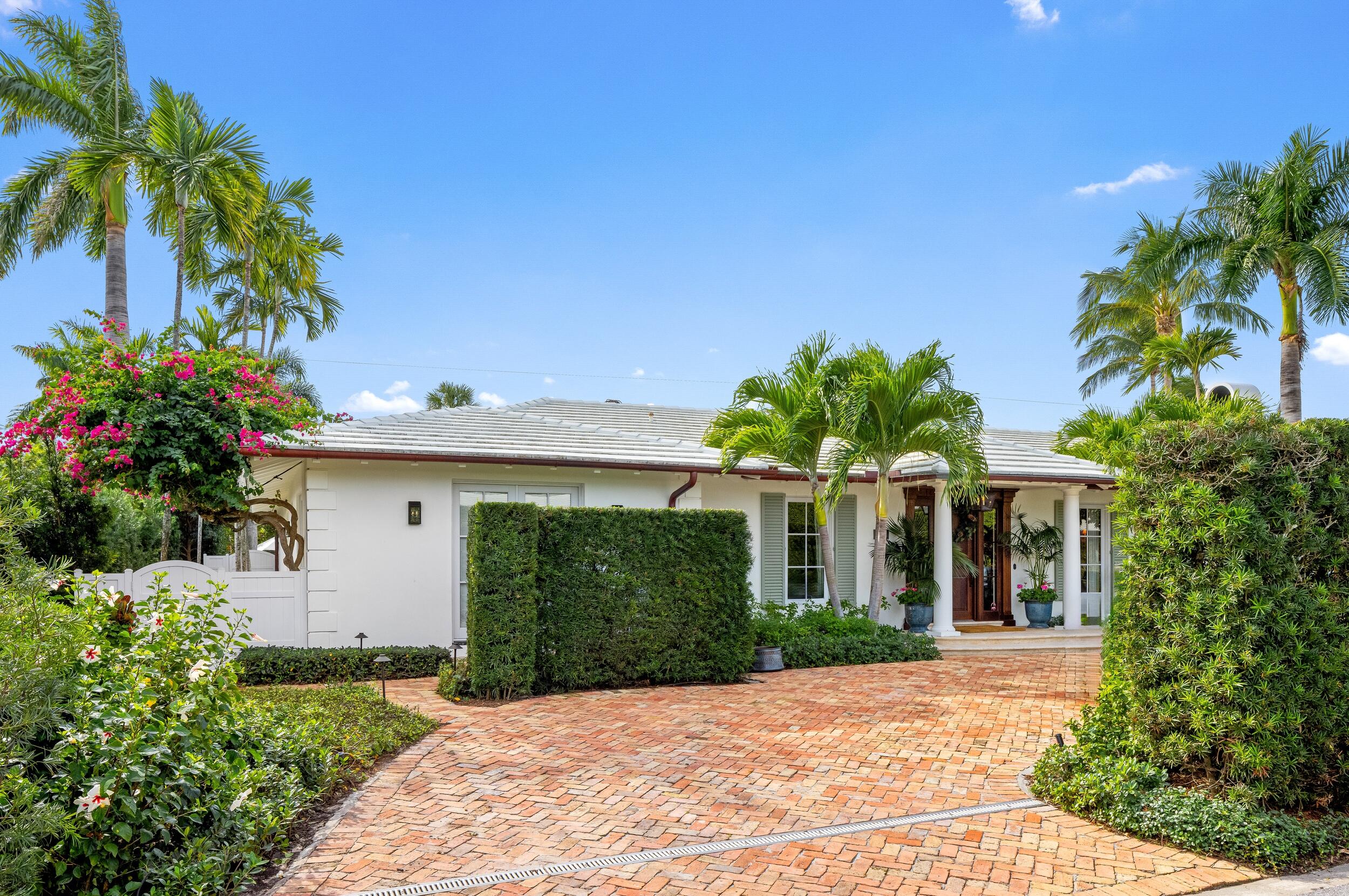258 List Road Palm Beach, FL 33480 - Photo 2 of 49 a front view of a house with a garden