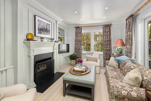 a bedroom with a bed and a flat tv screen on dresser