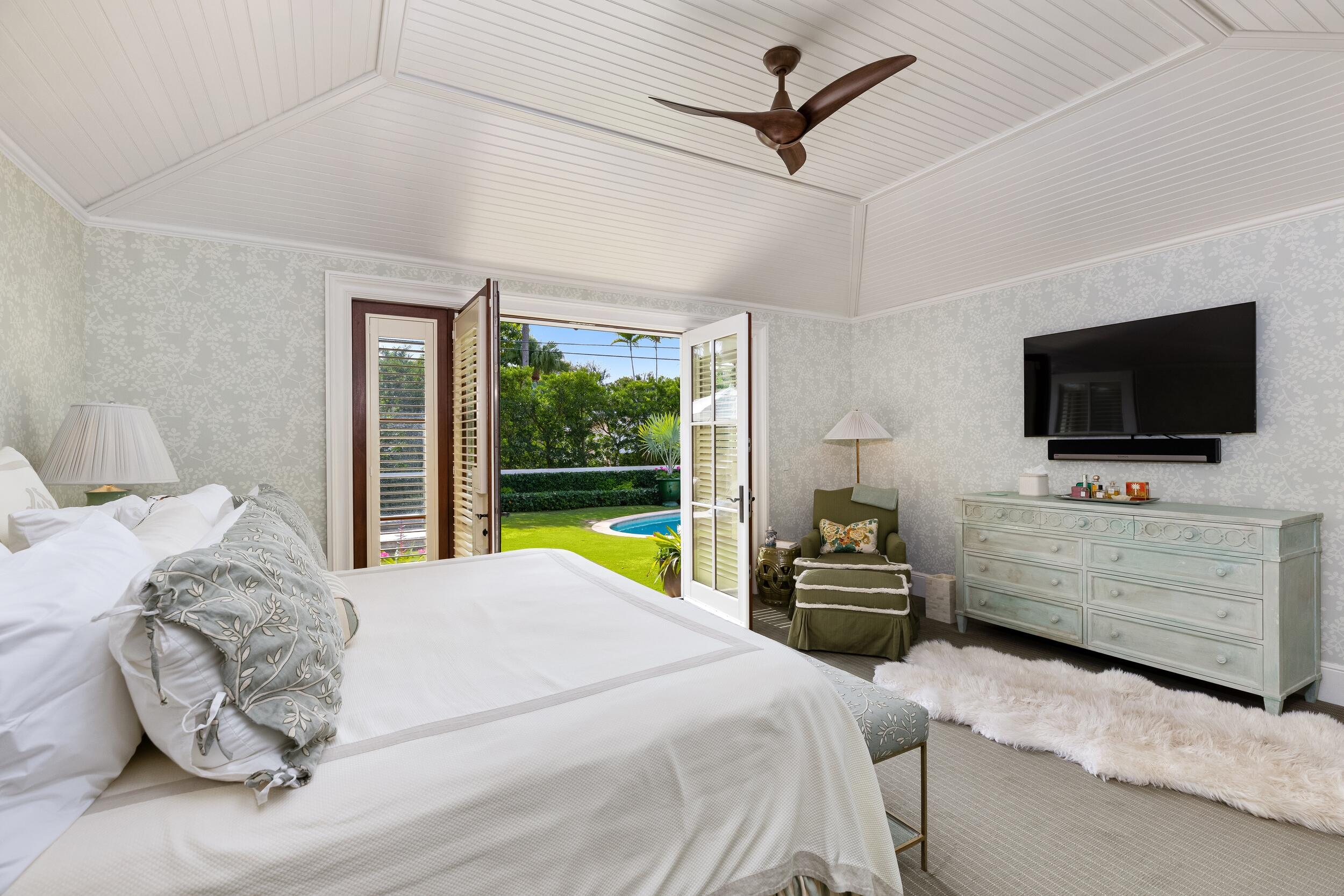 258 List Road Palm Beach, FL 33480 - Photo 29 of 49 a bedroom with a bed and a flat tv screen on dresser