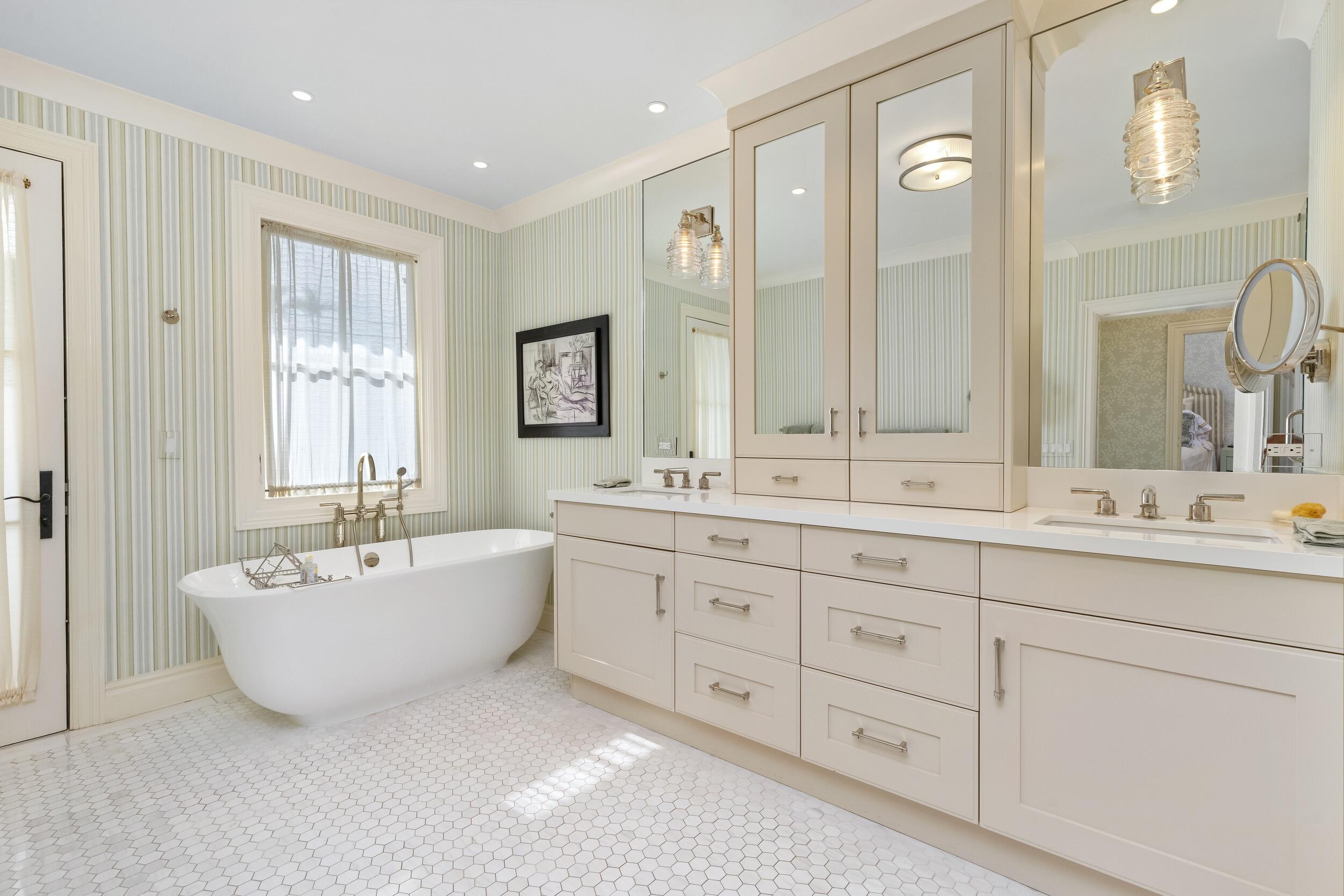 258 List Road Palm Beach, FL 33480 - Photo 30 of 49 a spacious bathroom with double vanity sinks a large mirror and a bathtub
