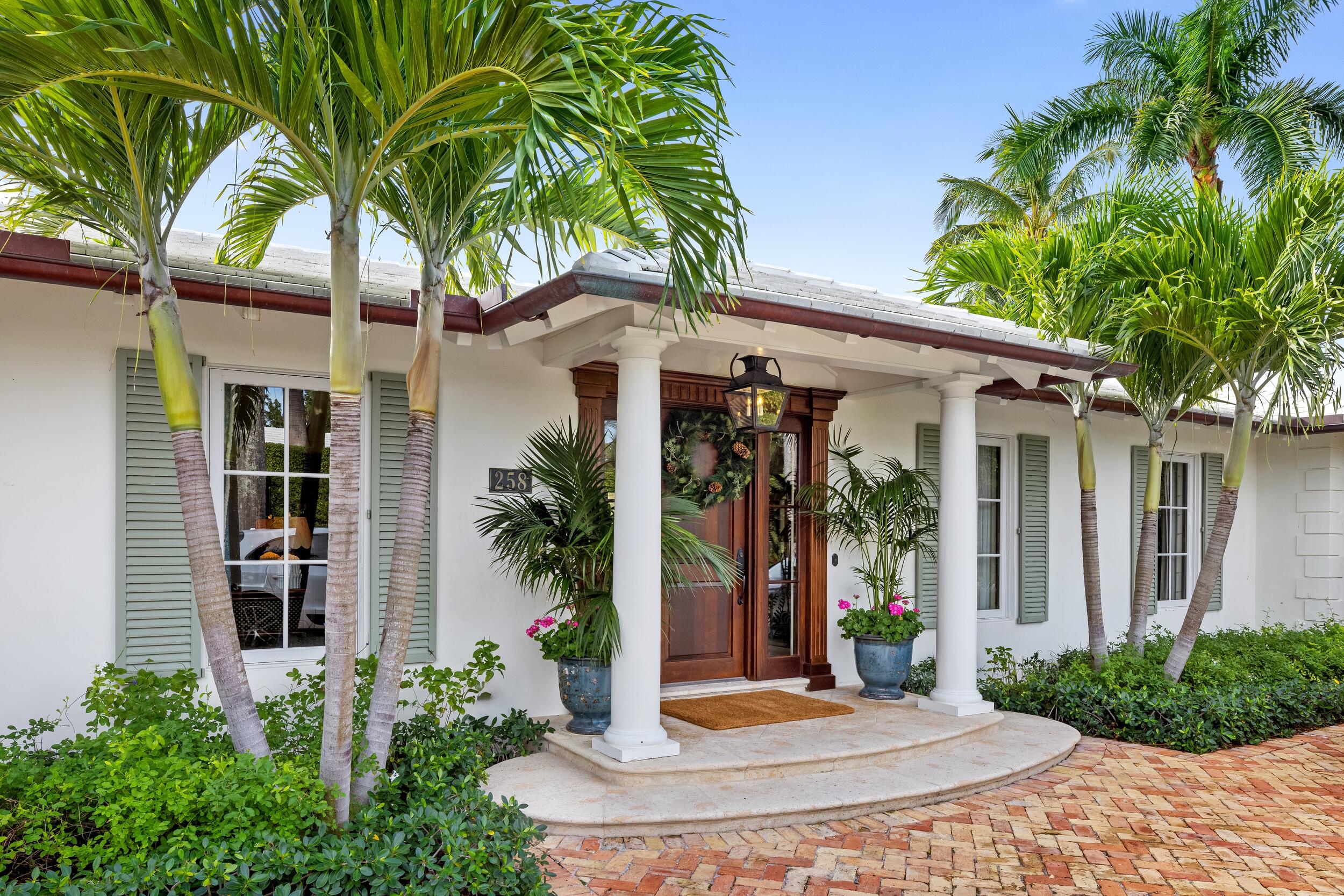 258 List Road Palm Beach, FL 33480 - Photo 3 of 49 a front view of a house with garden