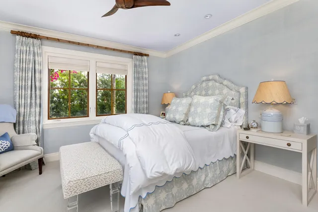 a front view of a house with porch and garden