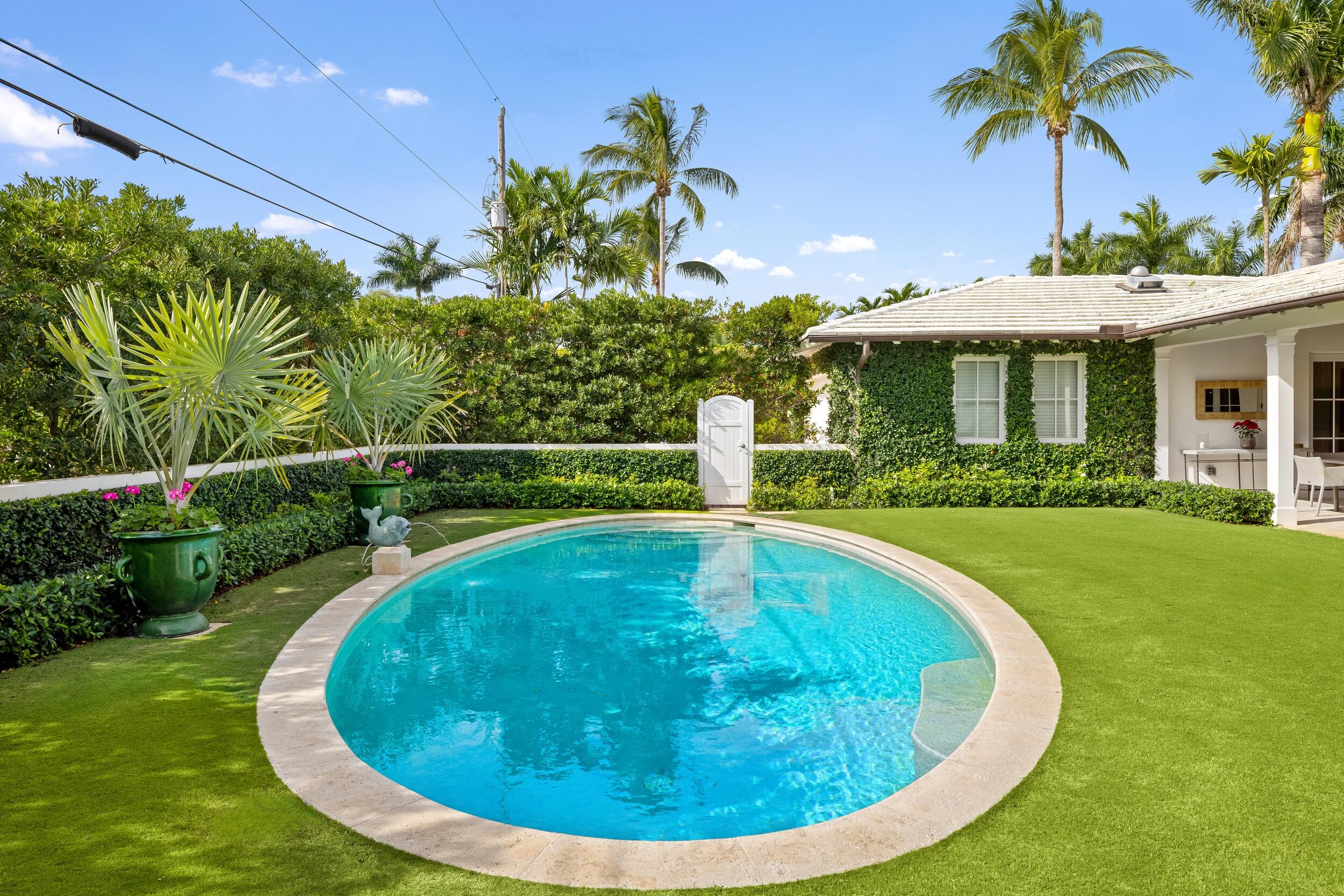258 List Road Palm Beach, FL 33480 - Photo 41 of 49 a view of a swimming pool with a garden
