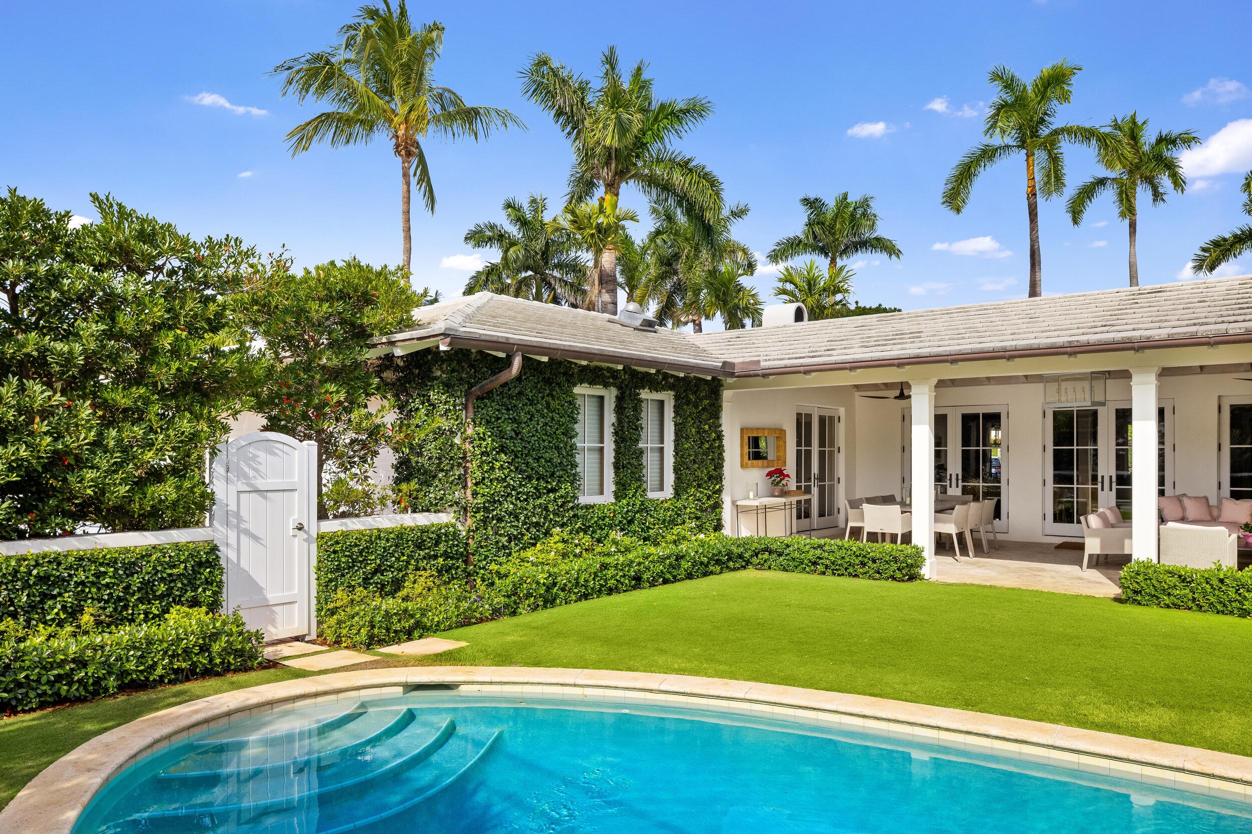 258 List Road Palm Beach, FL 33480 - Photo 42 of 49 a front view of a house with porch and garden
