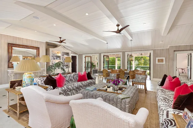 a living room with furniture and large windows