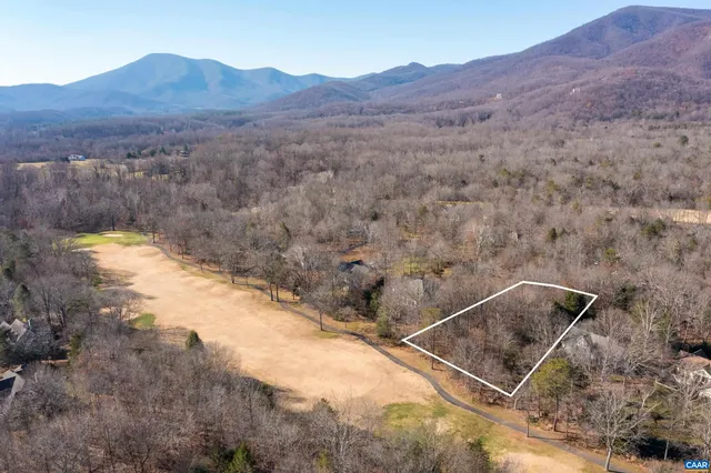 a view of a dry yard with mountains in the background