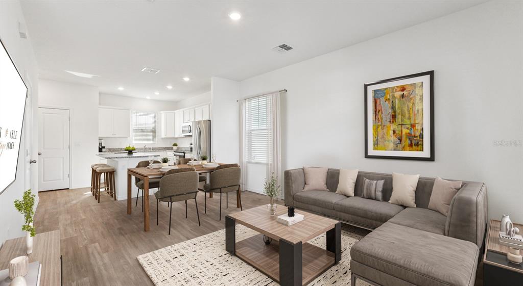 6499 Southwest 44th Street, Unit PINEHURST Gainesville, FL 32608 - Photo 3 of 19 a living room with furniture kitchen view and a dining table