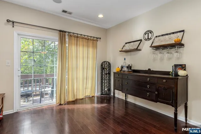 a view of a balcony with chair and wooden floor