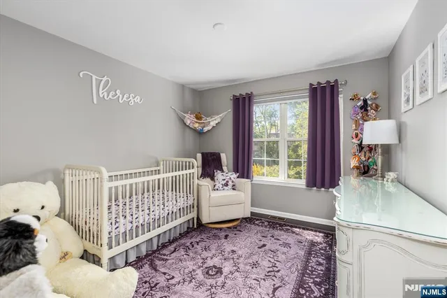 a bedroom with a baby crib and a couch