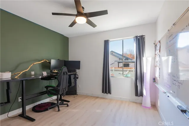 a view of a workspace with furniture and a window