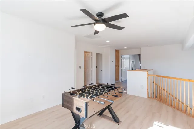 a living room with furniture and a ceiling fan