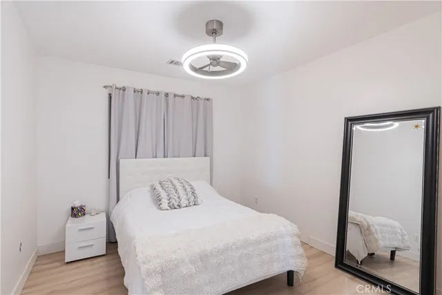 a bedroom with a bed and a mirror