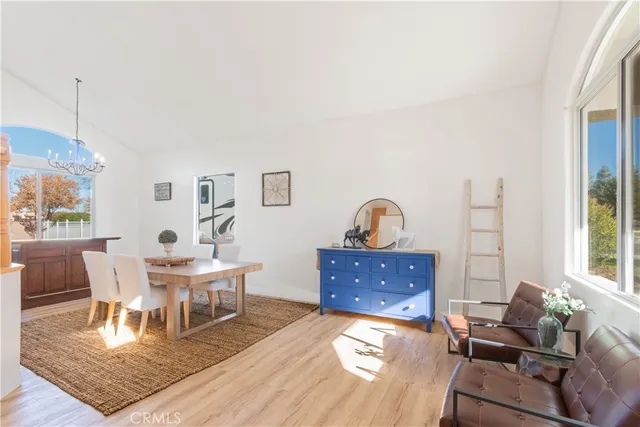 a living room with furniture a dining table and a window