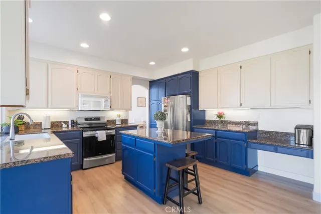 a kitchen with wooden cabinets and stainless steel appliances